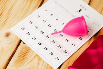 Calendar page and menstrual cup close up