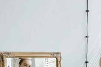 Confident plus size woman in sportswear looking at her reflection in a mirror indoors.
