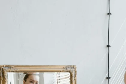 Confident plus size woman in sportswear looking at her reflection in a mirror indoors.