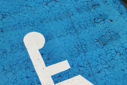 Parking space with wheelchair symbol on blue background for accessibility.