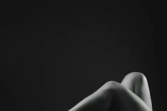 Artistic black and white capture of legs in high heels, exuding elegance and sensuality.