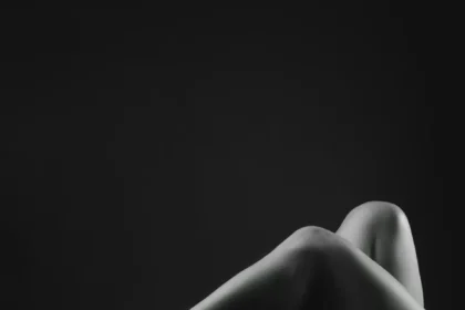 Artistic black and white capture of legs in high heels, exuding elegance and sensuality.