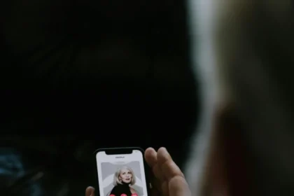 Person using a mobile dating app, highlighting smartphone technology and online connections.