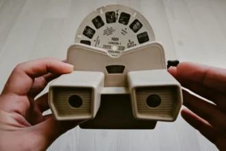 Close-up of a retro View-Master held by hands, displaying slide reels.
