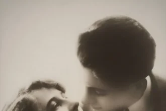 Classic black and white vintage portrait of a romantic couple sharing an affectionate moment.