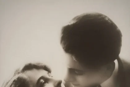 Classic black and white vintage portrait of a romantic couple sharing an affectionate moment.